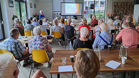 Groep mensen luistert naar een presentatie