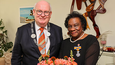 Burgemeester Frans Backhuijs bij de overhandiging van de koninklijke onderscheiding aan Lucia Martis